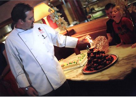 Chef Nick Musser lights the candles at icon Grill\'s 10-year-birthday celebration in August 2008. 