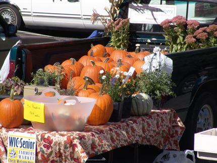 Pumpkins sit atop a farmer\'s table at the Yakima Farmers\' Market during the autumn months. 