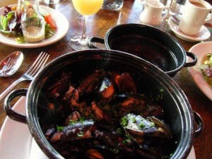 A steaming kettle of mussels at Maximilien-in-the-Market more than warms your tummy. 